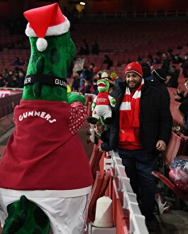 Arsenal v Sunderland - Carabao Cup 2021-22 Collection: Arsenal Fan's Excitement: Carabao Cup Quarterfinal at Emirates Stadium with Gunnersaurus Statue