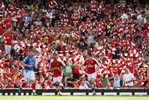 Arsenal v Portsmouth 2009-10 Collection: Arsenal fans hold up their scarves