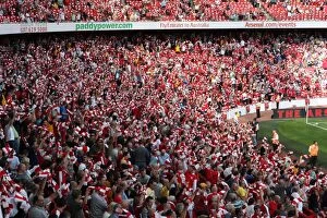 Arsenal v Portsmouth 2009-10 Collection: Arsenal fans hold up their scarves before the match