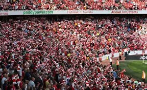 Arsenal v Portsmouth 2009-10 Collection: Arsenal fans hold up their scarves before the match