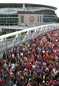 Arsenal fans make their way home after the match crossing