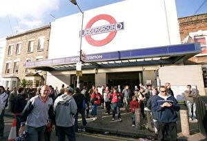 Fans Collection: Arsenal fans walk outside Arsenal Tube Station before the match