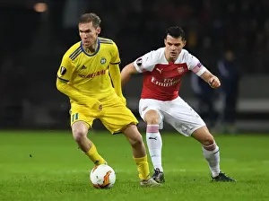 BATE Borisov V Arsenal 2018-19 Prints: Arsenal FC: Clash of Teammates - Hleb vs Xhaka in BATE Borisov Showdown (UEFA Europa League 2019)