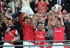 Arsenal FC: Mesut Ozil, Lukas Podolski, Mikel Arteta, and Thomas Vermaelen Lift the FA Cup after Arsenal's Victory over Hull City (2014)