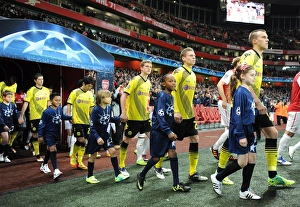 Arsenal V Borussia Dortmund 2011-12 Prints: Arsenal FC vs. Borussia Dortmund: Player Escorts in Champions League Showdown at Emirates Stadium (2011-12)