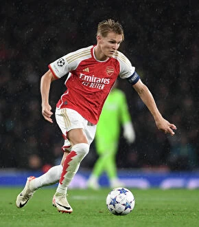 Arsenal v PSV Eindhoven 2023-24 Collection: Arsenal FC vs PSV Eindhoven: Champions League Clash - Martin Odegaard in Action