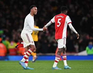 Images Dated 24th February 2022: Arsenal: Gabriel Magalhaes and Thomas Partey Share a Moment after Arsenal vs