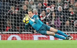 Images Dated 19th December 2009: Arsenal goalkeeper Manuel Almunia saves the Hull penalty taken by Geovanni
