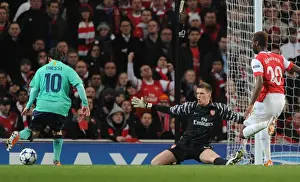 Arsenal goalkeeper Wojciech Szczesny closes down Barcelona forward Lionel Messi