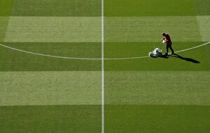Images Dated 26th September 2018: Arsenal Groundsman Meticulously Prepares Carabao Cup Pitch for Arsenal vs. Brentford