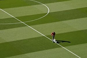 Images Dated 26th September 2018: Arsenal Groundsman Meticulously Prepares Emirates Stadium Pitch for Carabao Cup Match