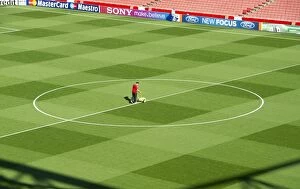 Images Dated 28th September 2011: Arsenal Groundsman Paul Ashcroft makes out the pitch before the match. Arsenal 2: 1 Olympiacos