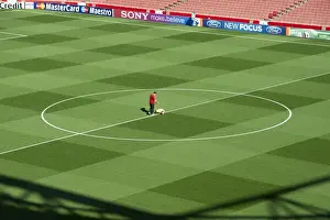Arsenal V Olympiacos 2011-12 Prints: Arsenal Groundsman Paul Ashcroft makes out the pitch before the match
