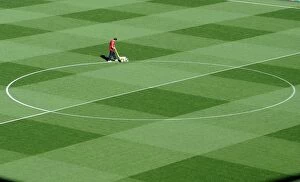 Arsenal v Olympiacos 2011-12 Collection: Arsenal Groundsman Paul Ashcroft marks out the pitch before the match. Arsenal 2: 1 Olympiacos