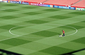 Images Dated 28th September 2011: Arsenal Groundsman Paul Ashcroft marks out the pitch before the match. Arsenal 2: 1 Olympiacos