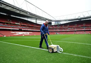 Arsenal Groundsman Prepares Pitch for FA Cup Match against Hull City