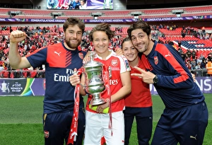Arsenal Ladies Celebrate FA Cup Victory: Katie McCabe, Josephine Henning, and Assistant Manager Jose Elena Lift the Trophy