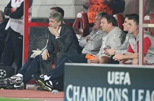 Images Dated 9th December 2009: Arsenal manager Arsene Wenger on the bench with assistant Pat Rice and kit man Vic Akers