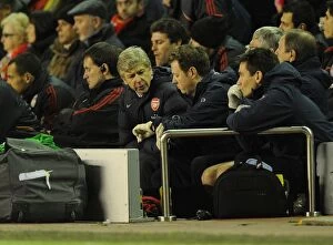 Images Dated 13th December 2009: Arsenal manager Arsene Wenger checks the time with physio Colin Lewin. Liverpool 1