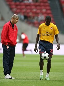 Arsenal v Seville Collection: Arsenal manager Arsene Wenger with Emmanuel Adebayor