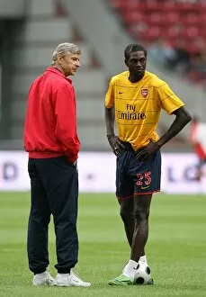 Arsenal v Seville Collection: Arsenal manager Arsene Wenger with Emmanuel Adebayor