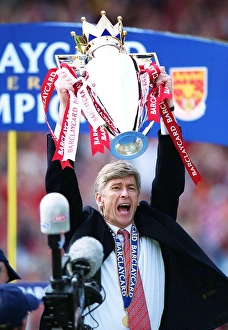 Arsenal manager Arsene Wenger lifts the F. A. Barclaycard Premiership Trophy