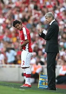 Arsenal manager Arsene Wenger with substitute Carlos Vela
