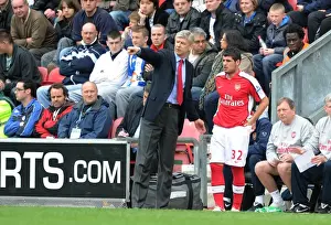 Wigan Athletic V Arsenal 2009-10 Prints: Arsenal manager Arsene Wenger with substitute Fran Merida. Wigan Athletic 3: 2 Arsenal