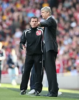 Arsenal manager Arsene Wenger talks with the 4th Official