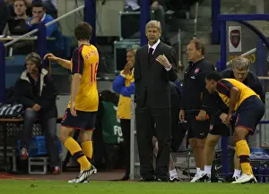 Arsenal manager Arsene Wenger talks to Aaron Ramsey during the match