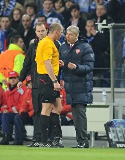Images Dated 17th February 2010: Arsenal manager Arsene Wenger talks to referee Martin Hansson after the 2nd Porto goal