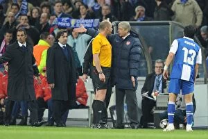 FC Porto v Arsenal 2009-10 Collection: Arsenal manager Arsene Wenger talks to referee Martin Hansson after the 2nd Porto goal