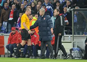 Arsenal manager Arsene Wenger talks to referee Martin Hansson after the 2nd Porto goal