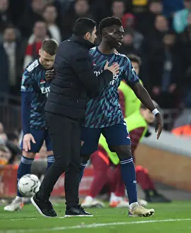 Arsenal Manager Mikel Arteta Guides Bukayo Saka at Liverpool's Anfield in Carabao Cup Semi-Final