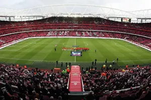 Arsenal and Manchester United shakes hands as the fans hold up Lace Up Save Lives cards