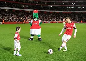 Arsenal v Chelsea - Capital One Cup 4th Rd 2013-14 Gallery: Arsenal mascot kicks a ball with Jack Wilshere (Arsenal) before the match. Arsenal 0: 2 Chelsea