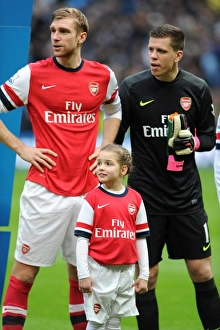 Arsenal Mascot with Per Mertesacker (Arsenal). Manchester City 6:3 Arsenal. Barclays Premier League. Etihad Stadium, Manchester, 14/12/13. Credit : Arsenal Football Club / David Price Images Dated 14th December 2013: Arsenal Mascot with Per Mertesacker (Arsenal). Manchester City 6: 3 Arsenal. Barclays Premier League
