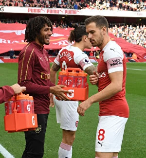 Images Dated 23rd September 2018: Arsenal: Mohamed Elneny Sharing Water with Aaron Ramsey Before Arsenal v Everton Match, 2018-19