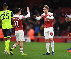 Arsenal v Huddersfield Town - 2018-19 Collection: Arsenal: Monreal and Torreira Celebrate Victory over Huddersfield Town