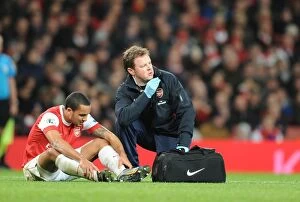 Arsenal v Stoke City 2010-2011 Collection: Arsenal physio Colin Lewin treats injured Theo Walcott. Arsenal 1: 0 Stoke City