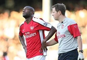 Fulham v Arsenal 2009-10 Collection: Arsenal physio Colin Lewin treats the injured William Gallas