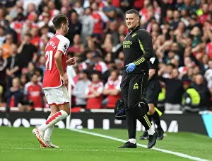 Arsenal Physio Simon Murphy Attends to Injured Player Amidst Intense Arsenal vs. Tottenham Clash (2023-24)