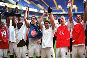 The Arsenal players celebrate Arsenal;s win in the photographers room (L>R) Gilberto