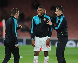Arsenal V Dinamo Zagreb 2015-16 Prints: Arsenal Players Jeff Reine-Adelaide and Gabriel Share a Light-Hearted Moment During Champions League Warm-Up