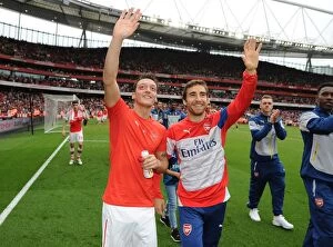 Arsenal v West Bromwich Albion 2014/15 Collection: Arsenal Players Mesut Ozil and Mathieu Flamini Waving to Fans after Arsenal vs
