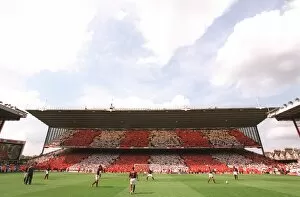 The Arsenal players warm up in front of the North Bank