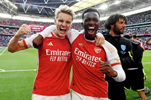 Arsenal Rejoice in Community Shield Triumph: Odegaard and Nketiah's Victory Embrace (2023-24)