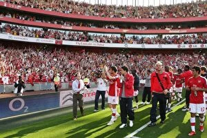 The Arsenal squad wave to the fans after the match