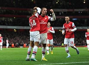 Arsenal v Newcastle United 2012-13 Collection: Arsenal Stars: Walcott and Podolski Celebrate First Goal Against Newcastle United (2012-13)