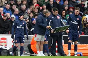 The Arsenal subs wait to come on. Andrey Arshavin (with hat), Eduardo and Aaron Ramsey